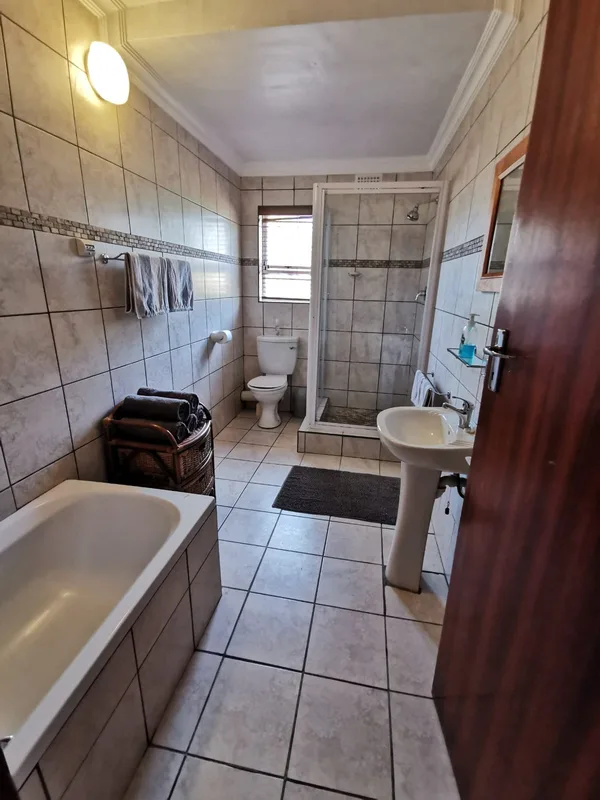 Spacious bathroom with deep bath and shower
