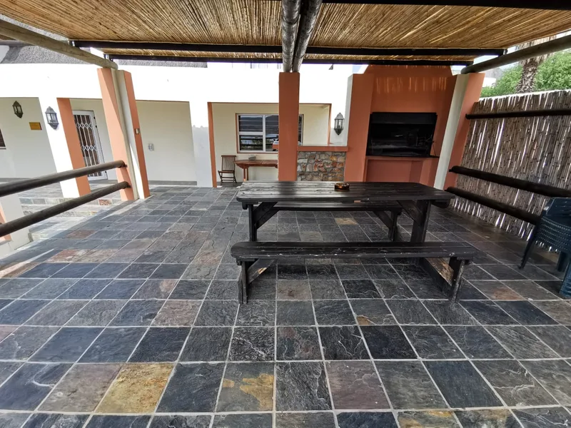 Authentic thatched braai lapa with dining table and built-in braai